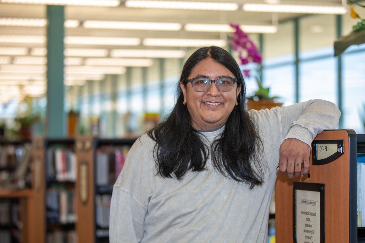 San Juan College student standing in SJC Library